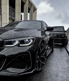 two black cars parked next to each other on the street