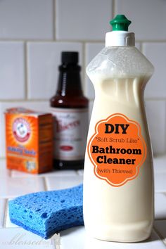 a bottle of diy bathroom cleaner sitting on a counter next to a blue sponge