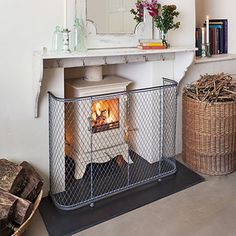 a fireplace in a living room next to a mirror and wicker baskets on the floor