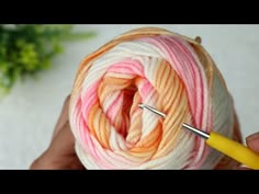 a ball of yarn being crocheted with a needle