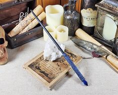 there are many items on the table including candles, bottles and other things to make it look like they were made from old books