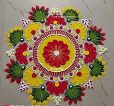 an intricate design on the floor with red and yellow flowers