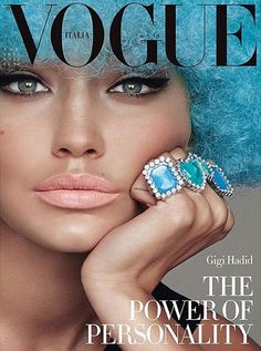 a woman with blue hair and ring on the cover of a magazine, wearing an aqua wig