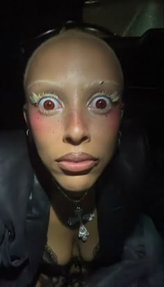 a creepy doll with big eyes and piercings