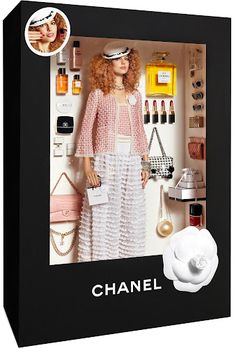 a woman standing in front of a display case with chanel perfumes on it