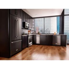 a modern kitchen with stainless steel appliances and wood flooring is featured in this ad