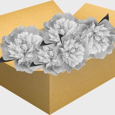 an open box with some flowers in it