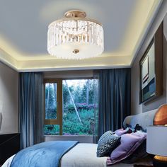 a bed room with a neatly made bed and a chandelier hanging from the ceiling