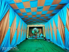 an open room with blue drapes covering the ceiling and walls, decorated with decorations