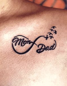 a man with a tattoo on his chest that says, mom and dad written in cursive writing