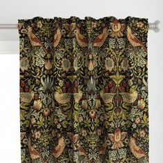 the curtain is hanging in front of a window with an ornate pattern and birds on it