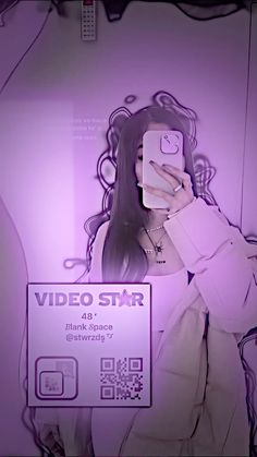 a woman taking a selfie in front of a purple background with the words video star on it