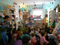 a group of children in a room filled with books