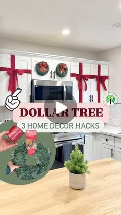 a kitchen with white cabinets and christmas decorations on the wall, and a wooden table in front of it