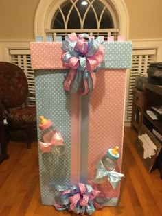 a baby shower gift set up on the floor in front of a window with polka dots