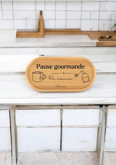 a wooden sign that says pause gourmande on the side of a counter