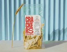 a bag of crackers sitting on top of a table next to a blue curtain