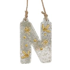 the letter n is made out of glass and has gold bees on it's sides