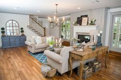 a living room filled with furniture and a fire place in the middle of a room