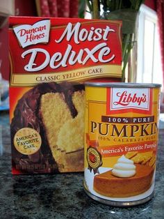 a can of cake mix next to a cupcake with frosting and powdered sugar