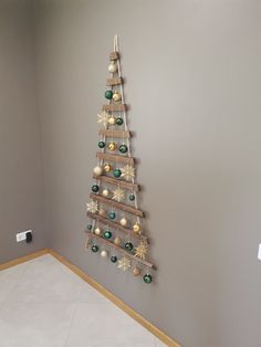 a christmas tree made out of wooden pallets on the wall next to a white floor