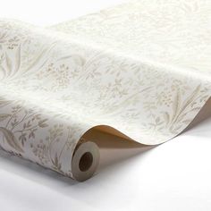 a roll of white paper with floral designs on it