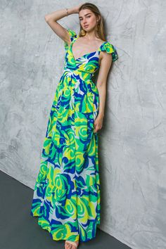 This gorgeous floral-printed woven maxi dress features a flattering V neckline, a waist yoke, tiered skirt, smocked back for comfort and flexibility, and high-quality woven fabric. Its captivating print and romantic bohemian vibe is perfect for any event, making you look and feel stunning. Enjoy the beauty of nature and the comfort of this dress. Details Self: 100% Polyester Lining: 100% Polyester Size & Fit - Model is 5`8 " And Wearing Size Small - Measurements Taken From Size Small - Approx. L Blue Tiered Skirt Maxi Dress For Spring, Green Smocked Bodice Tiered Skirt Dress, Green Smocked Back Maxi Dress For Summer, Green Maxi Dress With Smocked Back For Summer, Green Sundress With Tiered Skirt, Green Sundress Maxi Dress For Brunch, Green Maxi Dress With Smocked Bodice For Spring, Green Maxi Dress With Smocked Back For Spring, Blue Tiered Maxi Dress For Vacation