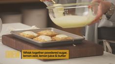 a person pouring milk into a pan filled with pastries