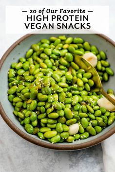 a bowl full of green beans with the title overlay reads 20 of our favorite high protein vegan snacks