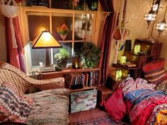 a living room filled with lots of furniture next to a book shelf and window sill