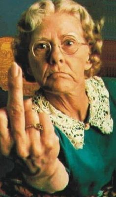 an older woman making the middle finger sign