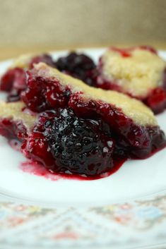 two pieces of pie on a plate with blueberries