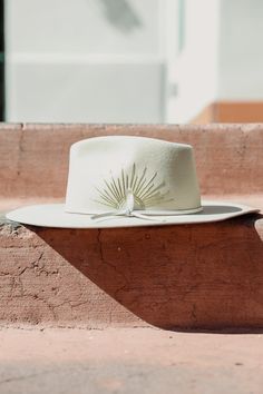 Details The McVie Hat by Wyeth is a fun, unique hat that will quickly become your newest go-to! This Australian cashmere wool hat features a wide brim, a genuine leather tie band, hand-stitched sun embroidery detailing and a Selenite crystal! Rancher style Wide brim All accessories are final sale. Contents 100% Cashmere wool Genuine leather band Care Spot clean using a damp cloth and mild soap. Air dry in a space out of direct sunlight. Western Formal, Casual Wedding Outfit, Bohemian Hat, Sun Embroidery, Custom Cowboy Hats, Hat Bar, Hat Aesthetic, Rose Hat, Boho Hat