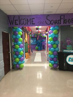 an entrance decorated with balloons and streamers for a children's birthday party at the school