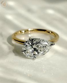 a close up of a diamond ring on a table