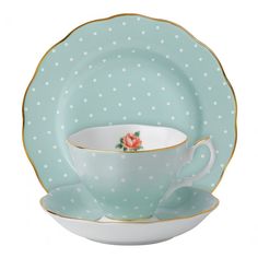 a polka dot tea cup and saucer set on a white background with gold trim