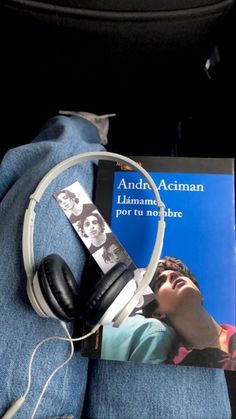 headphones and book on the back seat of a car, with an mp3 player attached to it