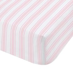 a pink and white striped sheet on top of a bed