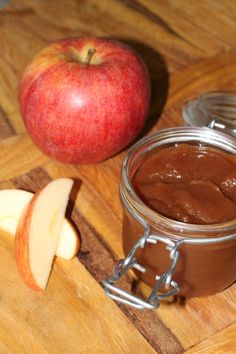 an apple and chocolate spread on a cutting board