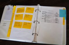 an open planner with yellow sticky notes on it