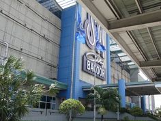 the outside of a building with palm trees in front of it and an awning