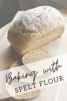 a loaf of bread sitting on top of a cutting board with the words baking with spelt flour