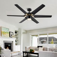 a living room with couches and a ceiling fan in the middle of the room