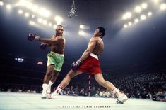 two men standing in a ring with boxing gloves on