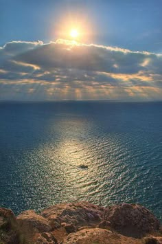 the sun is shining over the ocean on a sunny day