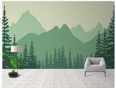 a living room with a couch and chair in front of a mountain scene wall mural