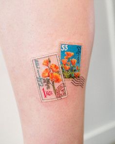 two postage stamps with flowers on them are attached to the legs of a woman's leg