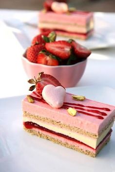 two slices of cake with strawberries on top