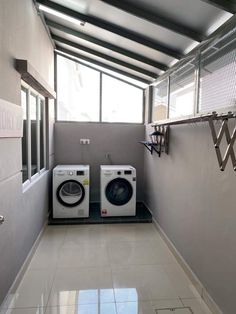 two washers and dryer in a small room