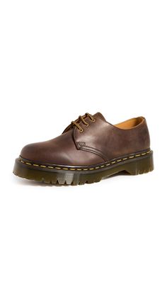 PRICES MAY VARY. The solid style of the Dr. Martens 1461 Bex shoe lets you dress them up or dress them down to match your everyday style. Crazy Horse is a heavyweight leather with a tough, textured appearance — designed to look worn in from the first step Includes classic Doc's DNA like yellow welt stitching, three eyelets, and a grooved air-cushioned sole. Traditional lace-up closure with sturdy fabric laces and metal eyelets for a secure fit. Goodyear welt construction where the upper and sole Brown Low Doc Martens, Crazy Horse Doc Martens, Brown Doc Martens Outfit, Shoes Thrift, Brown Docs, Low Doc Martens, Doc Martens Oxfords, Doc Martens Loafers, Brown Doc Martens